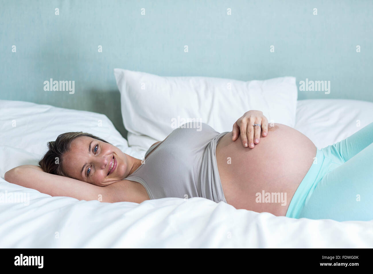 Pregnant woman lying on her bead Banque D'Images