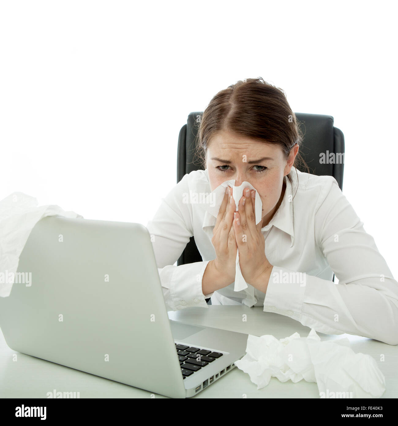 Jeune brunette business woman est malade avec ordinateur portable derrière des mouchoirs Banque D'Images