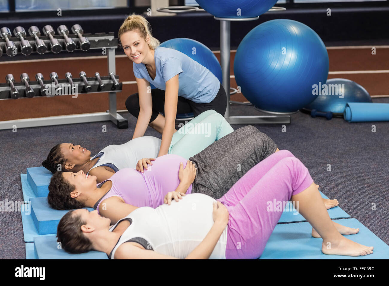 Fitness Trainer train aider les femmes enceintes Banque D'Images