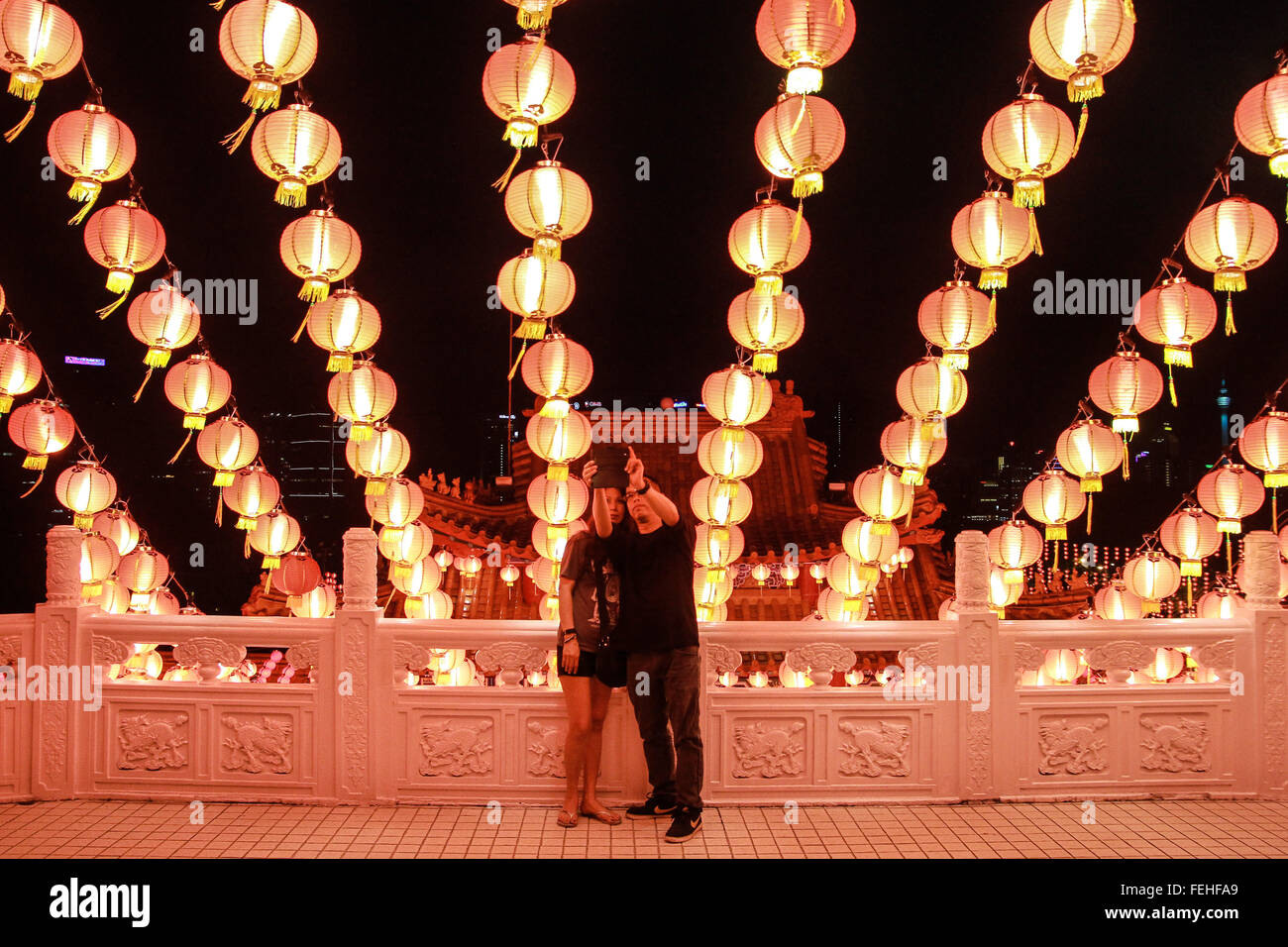 Kuala Lumpur, Malaisie. 7 Février, 2016. Couple est vu en prenant un verre sous selfies Thean Hou Temple à décoration à Kuala Lumpur pendant le réveillon du Nouvel An chinois. Selon le calendrier chinois, le Nouvel An lunaire aura lieu le 8 février de cette année. Il a également connu comme le Festival de Printemps. Credit : Shafwan Zaidon/Alamy Live News Banque D'Images