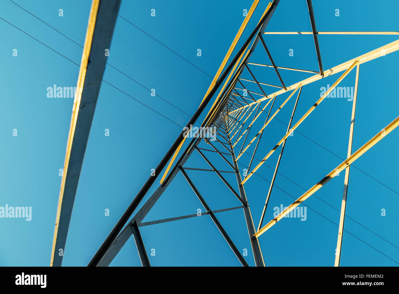 Tour de transmission, l'électricité à haute tension pylône avec les fils bleu ciel de l'après-midi, contre grand angle faible Banque D'Images Tour de transmission, l'électricité à haute tension pylône avec les fils bleu ciel de l'après-midi, contre grand angle faible Banque D'Images