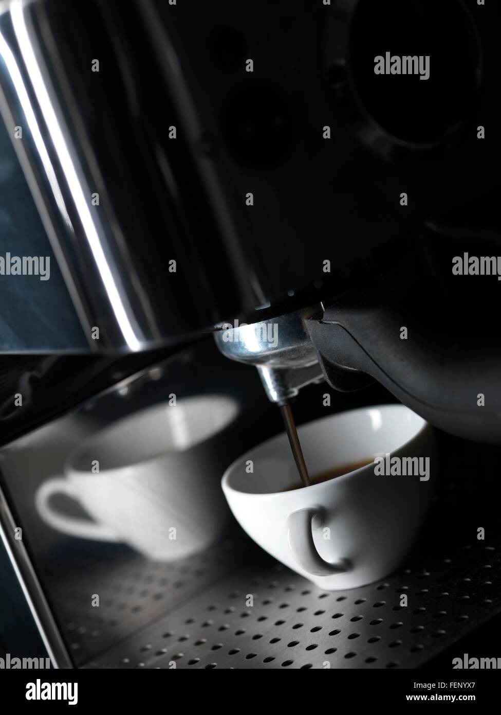 Du café frais et verser dans la tasse de café blanc à partir de la machine à café Banque D'Images