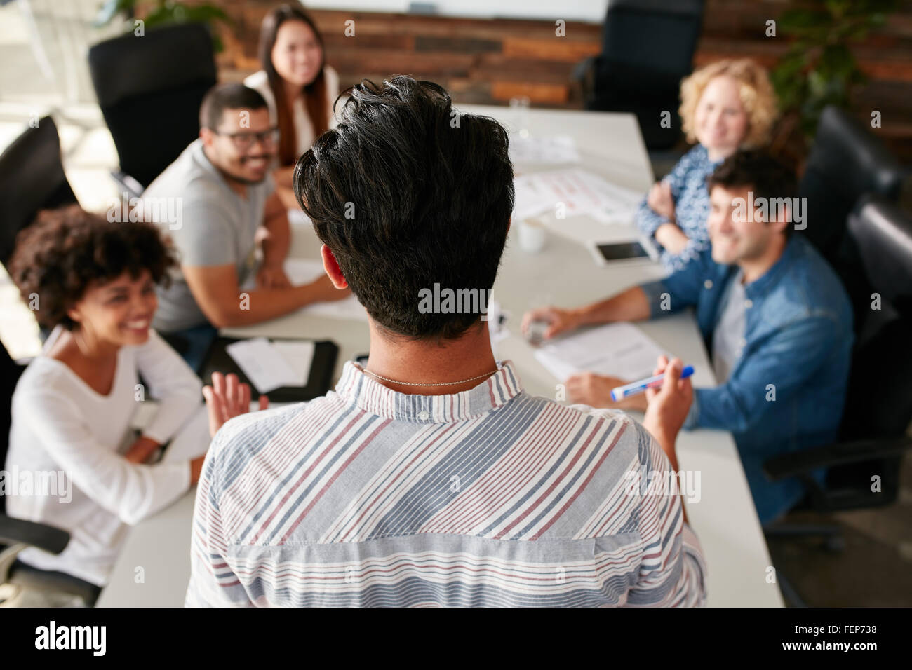 Vue arrière portrait d'un homme expliquant les idées de vos collègues lors d'une réunion dans la salle de conférence. Réunion de jeunes Banque D'Images