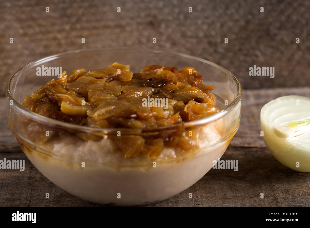 La nourriture traditionnelle purée de haricots 'iahnie' avec des oignons frits, au-dessus, dans un bol transparent Banque D'Images