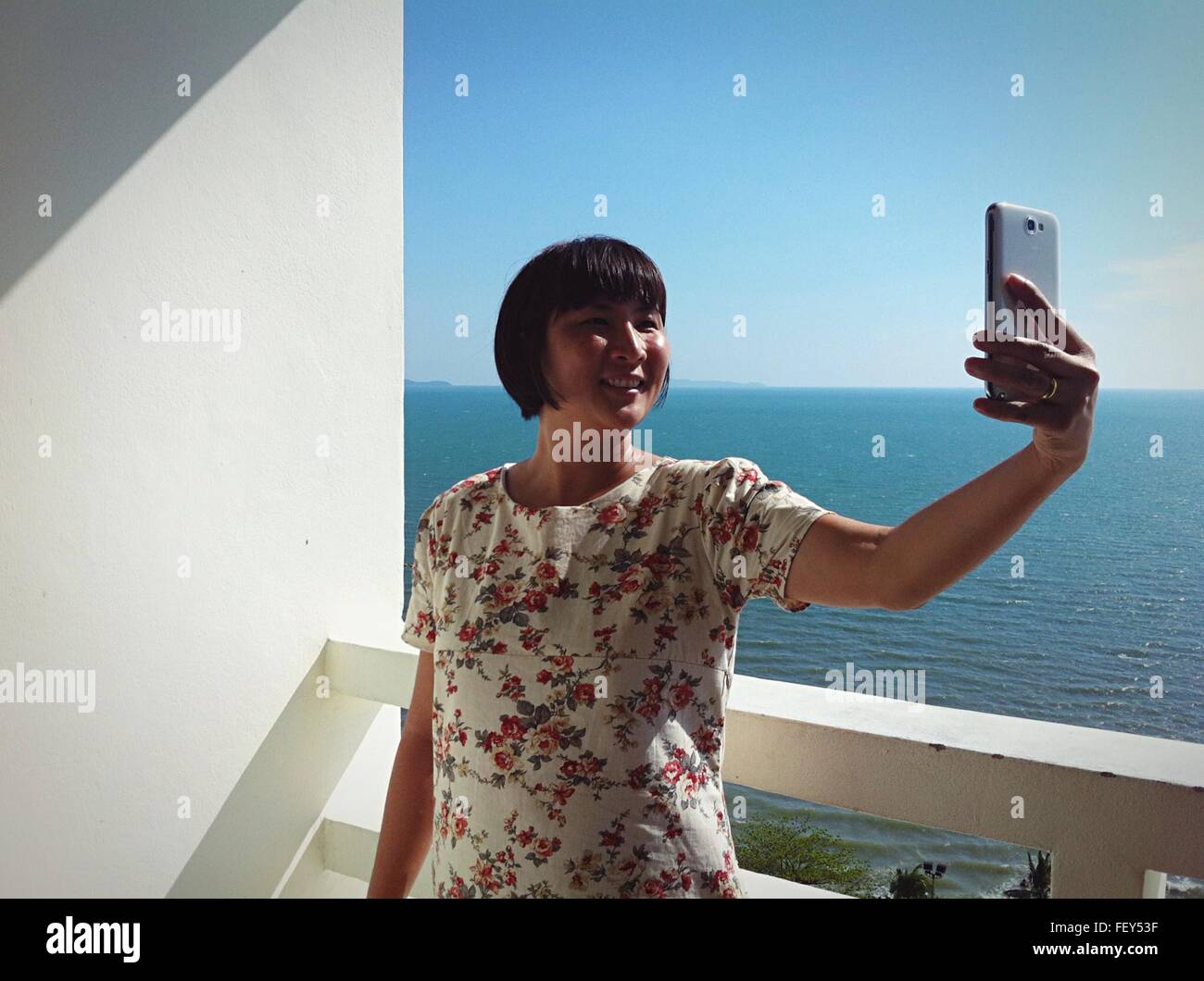Happy Young Woman Against Wall Selfies Banque D'Images