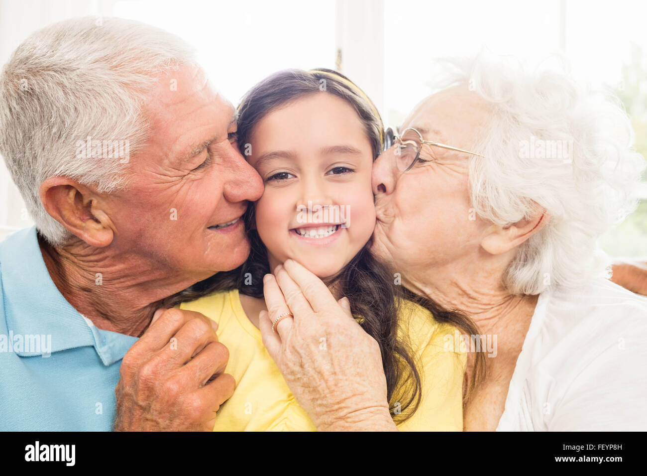 Les grands-parents s'embrasser leur petite-fille Banque D'Images