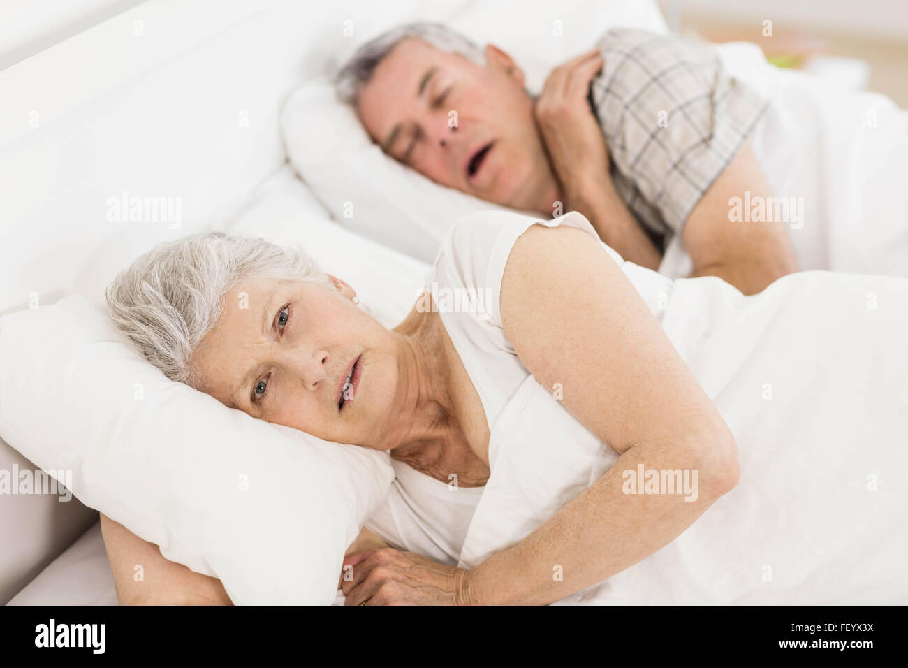 Awake senior woman in bed Banque D'Images