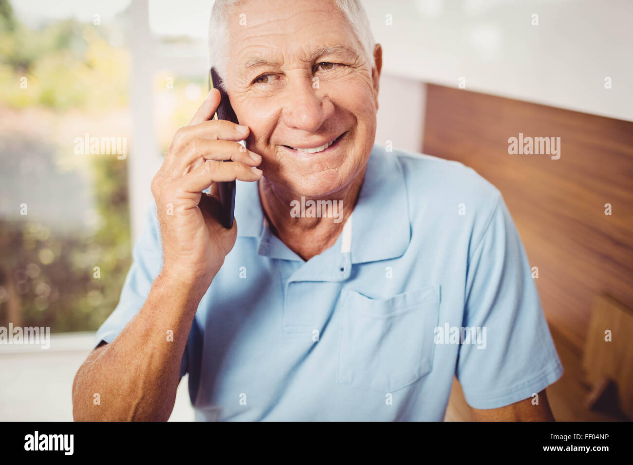 Smiling senior homme sur un appel téléphonique Banque D'Images