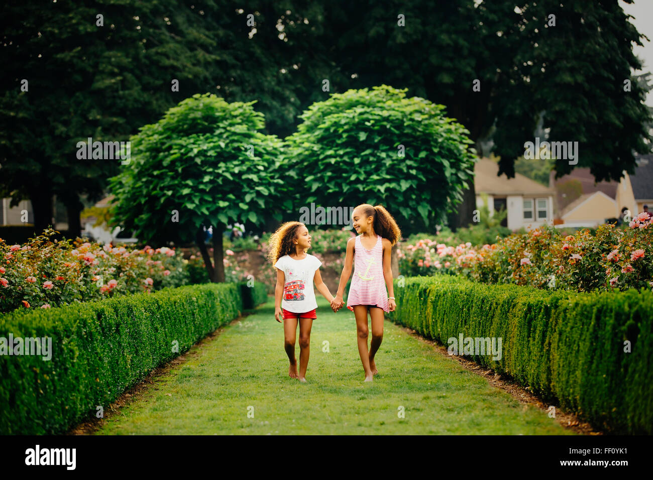 Mixed Race girl walking in garden Banque D'Images
