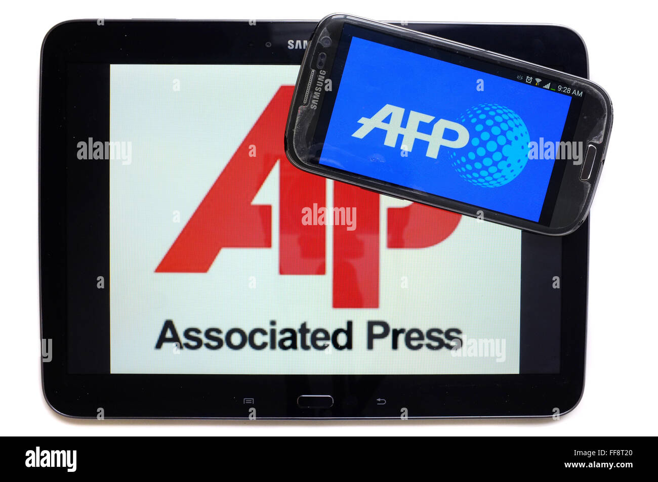 Les agences de presse AFP et AP sur les écrans d'une tablette et un smartphone photographié sur un fond blanc. Banque D'Images
