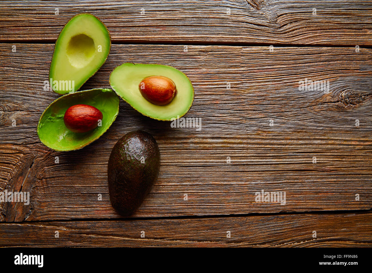 Couper l'avocat sur le bois de chauffage coupé la moitié du tableau Banque D'Images