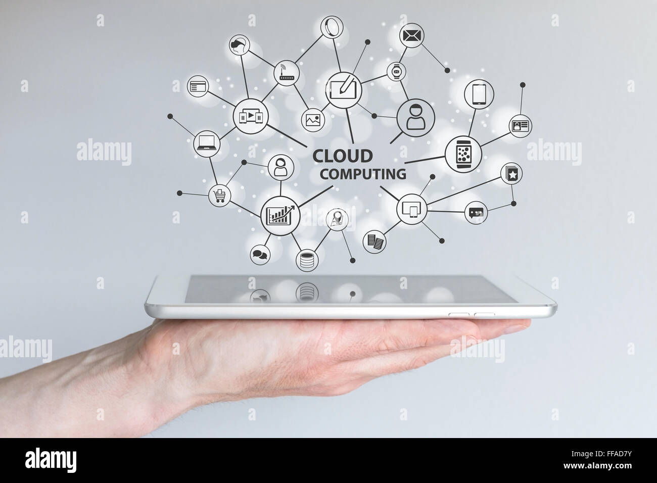 Le cloud computing et l'informatique mobile concept. Main tenant une tablette ou un téléphone intelligent. Réseau cloud d'appareils connectés Banque D'Images