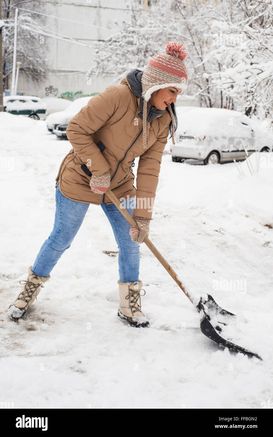 Nettoyage à la neige femme gratuit en journée froide Banque D'Images