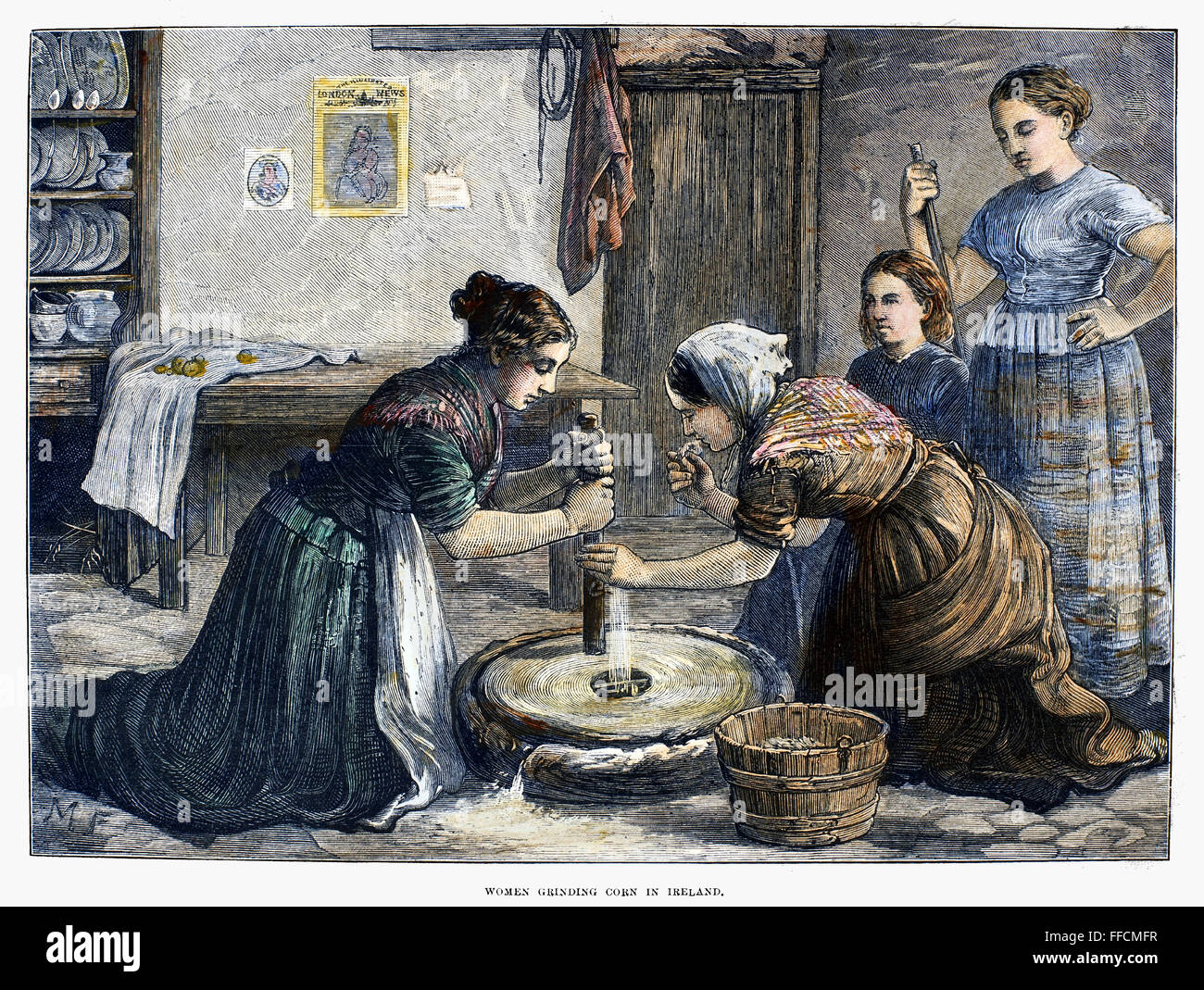 Irlande : MOULIN MANUEL, 1874. /NIrish paysannes à l'aide d'un moulin pour moudre les grains de céréales en farine. La gravure sur bois, anglais, 1874. Banque D'Images