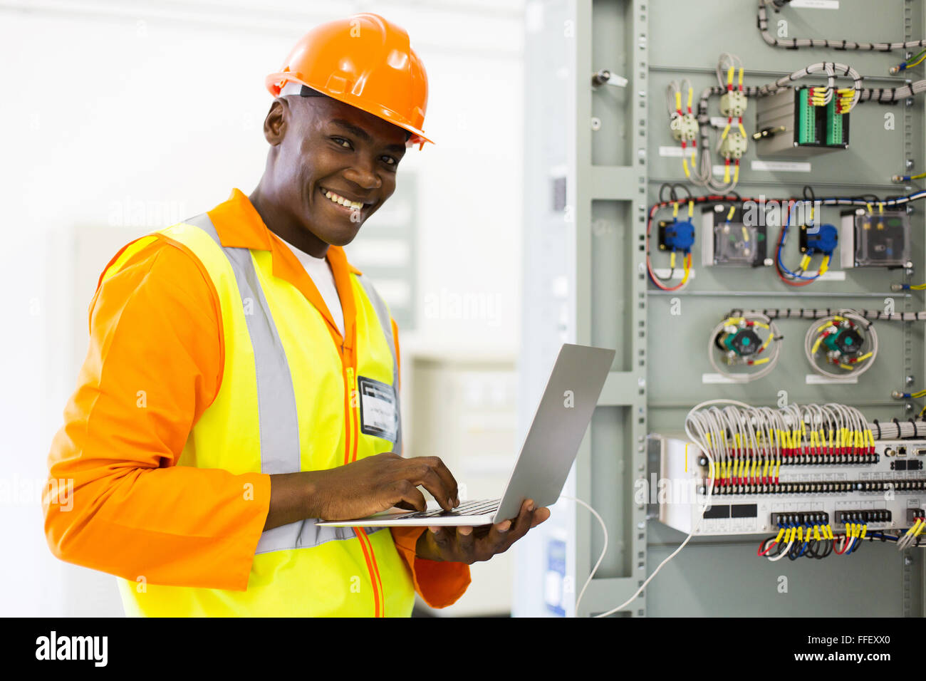 Ingénieur en électricité de l'Afrique de l'ordinateur portable à l'aide de contrôle de l'état de la machine Banque D'Images