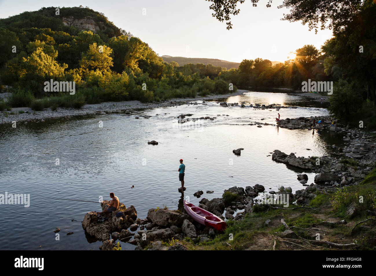 La pêche dans la rivière Ardèche sur une paisible soirée d'été, Vallon-Pont-d'Arc, France. Banque D'Images