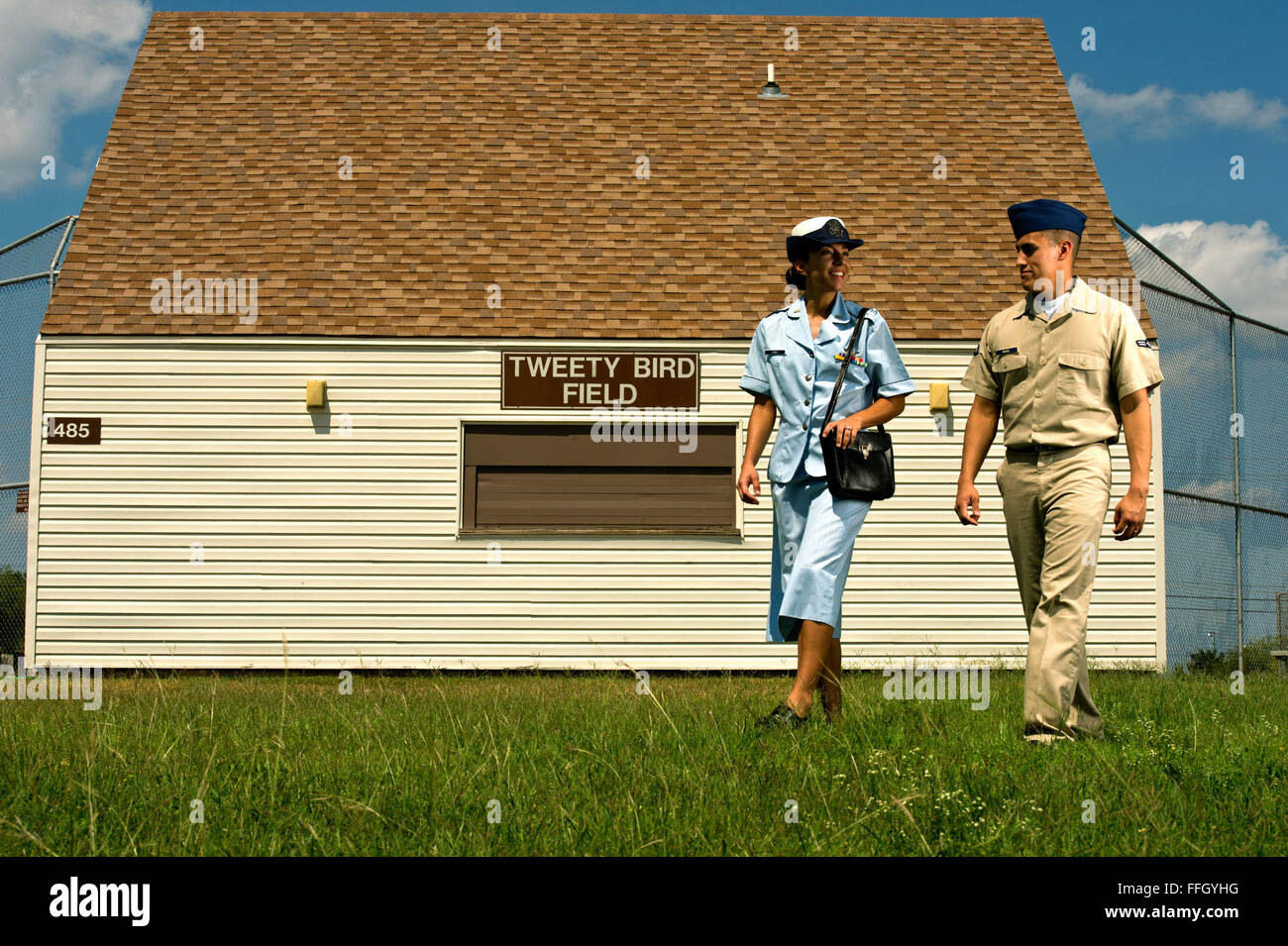 Deuxième lieutenant Angela Martin (à gauche) porte une des années 1960, les femmes dans l'Armée de l'air uniforme seersucker et Slt James Ramirez porte l'ombre uniforme kaki 1505 tout en passant par un terrain de baseball à Laughlin Air Force Base, Texas. Banque D'Images