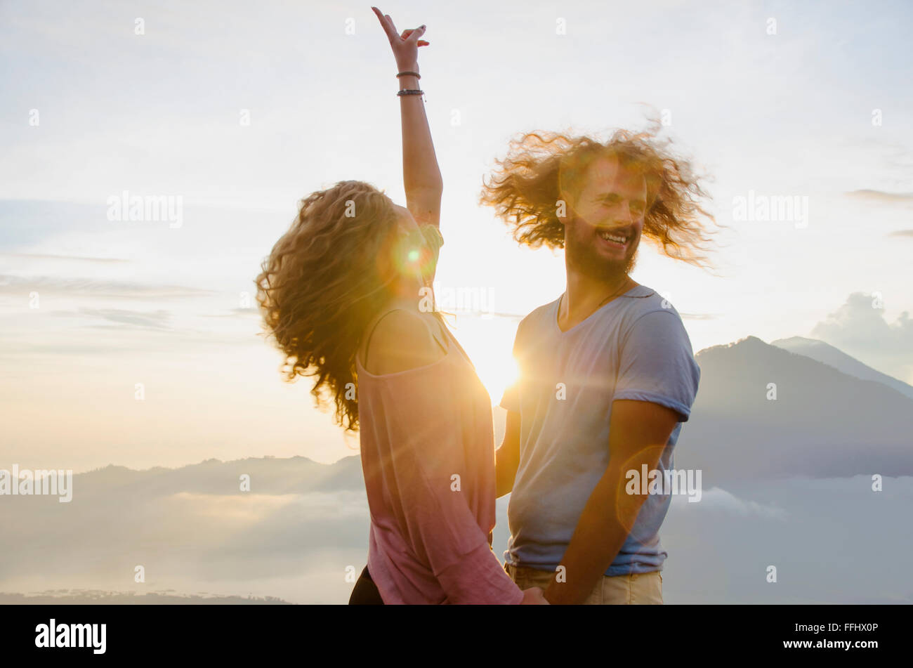 Couple heureux au soleil sur un fond de montagnes. image. Banque D'Images