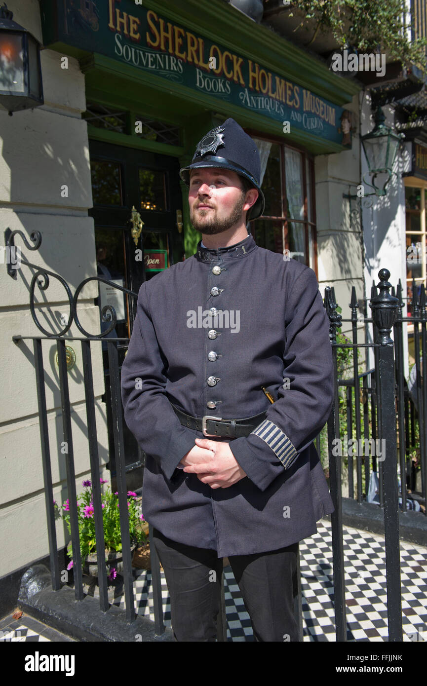 Un homme en costume (ancien uniforme de la police) à l'extérieur de la célèbre Musée Sherlock Holmes à Baker Street, London, United Kingdom. Banque D'Images