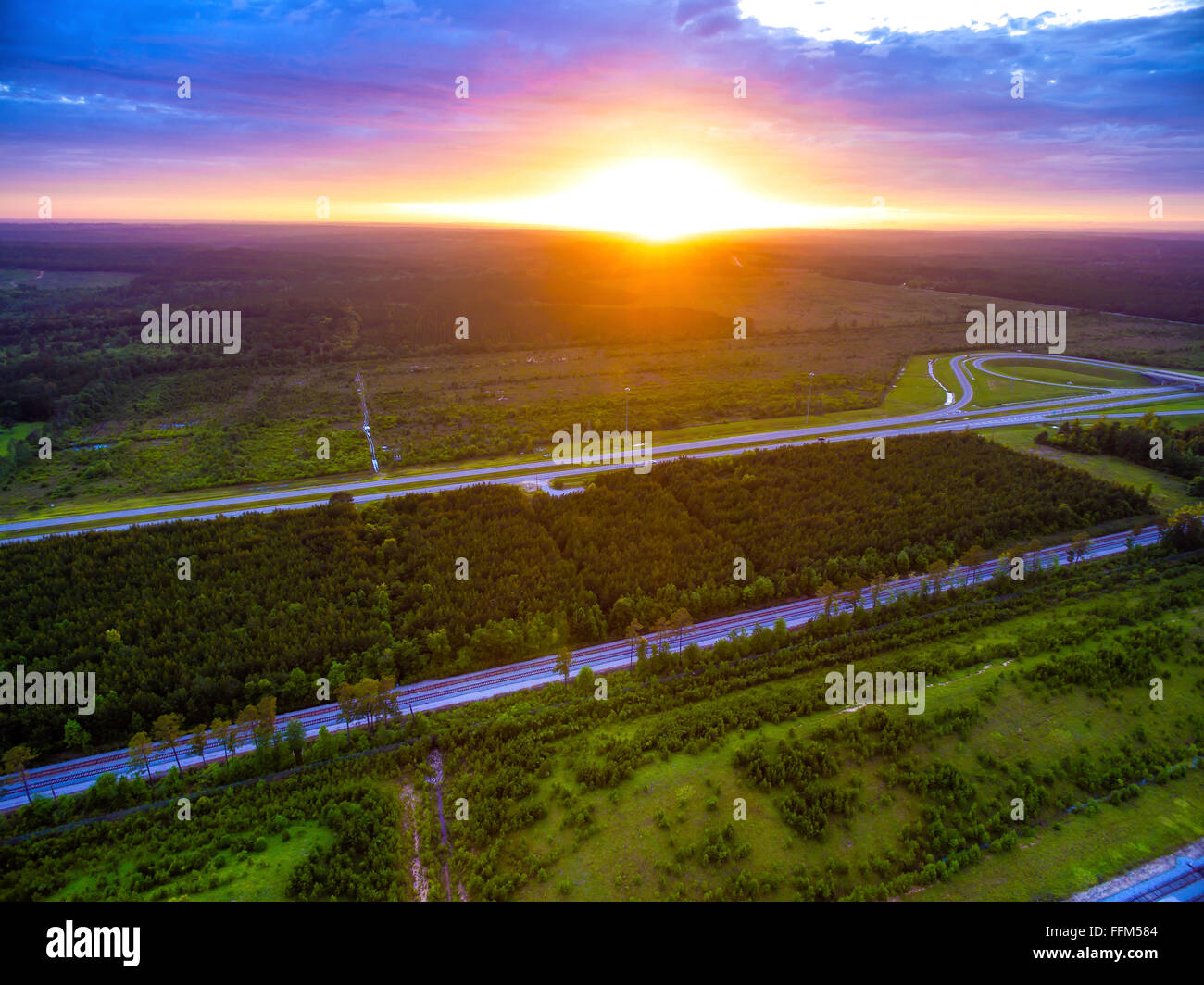 - Vue aérienne drone de soleil sur les arbres et les forêts de l'Alabama routes et voies ferrées avec ciel rempli de nuages Banque D'Images