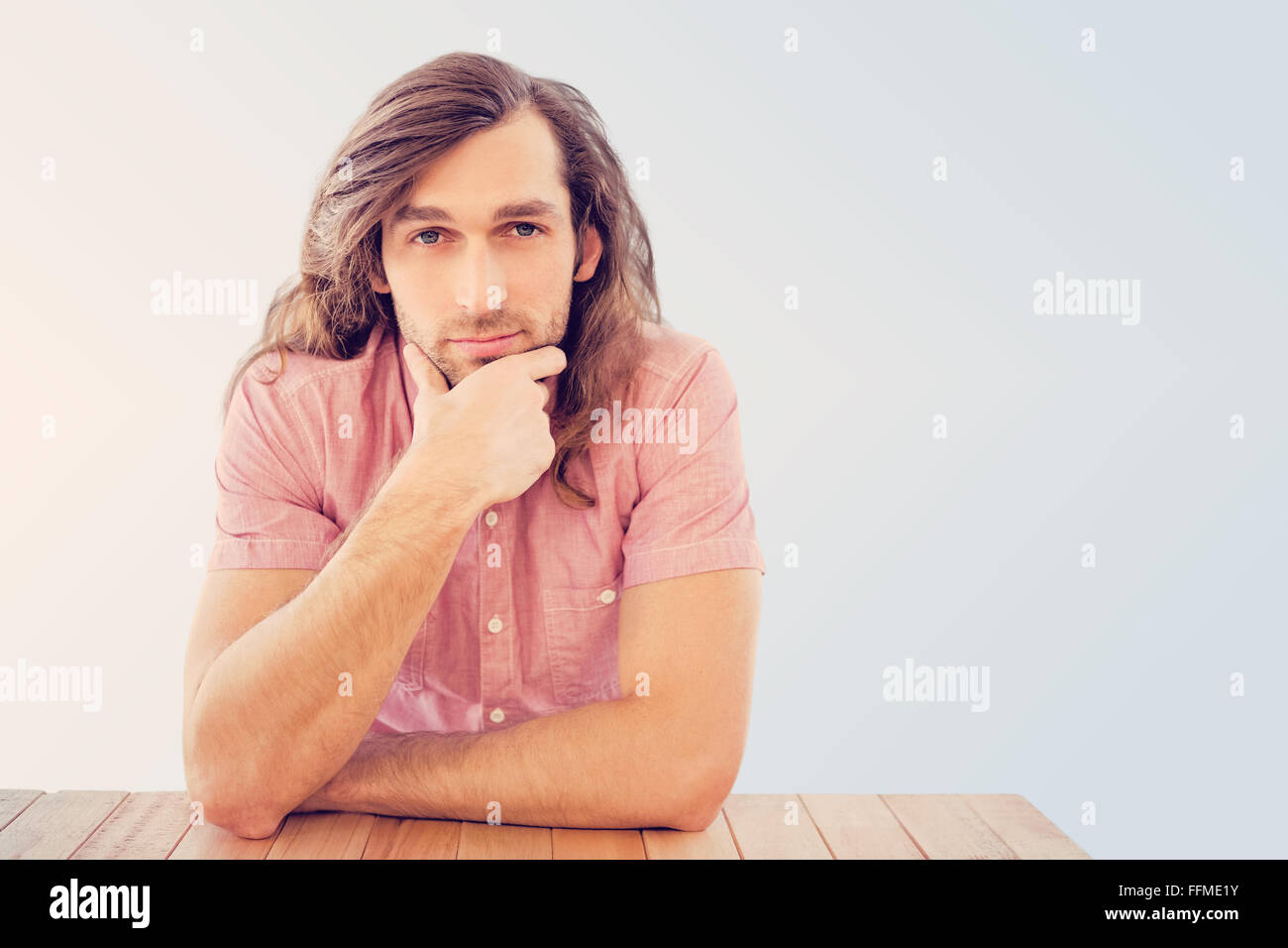 Image composite de Young man with hand on chin Banque D'Images