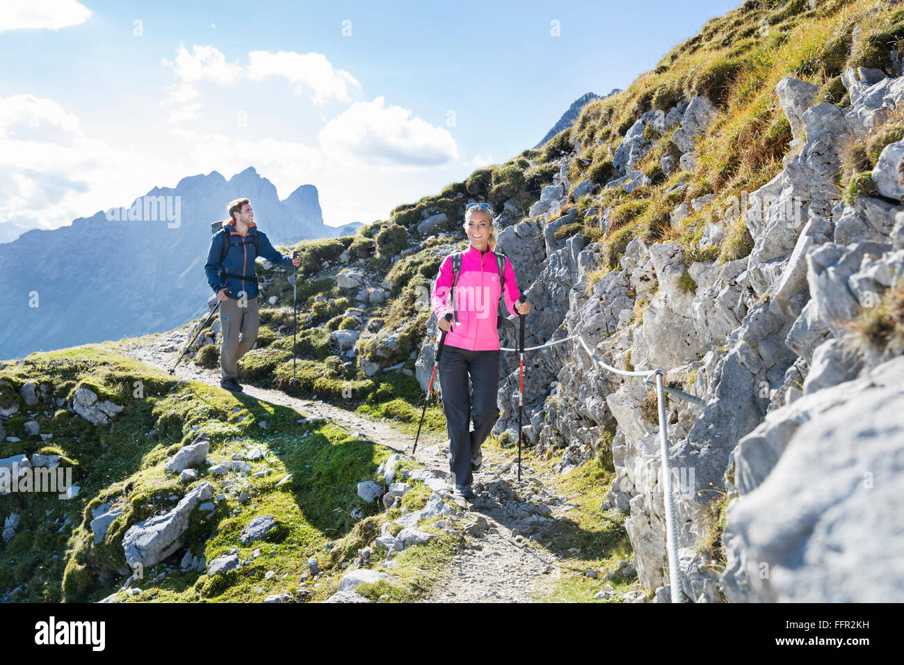 Les randonneurs, l'homme et la femme sur un sentier de randonnée avec corde de sécurité Goetheweg, Karwendel, Innsbruck, Tyrol, Autriche Banque D'Images
