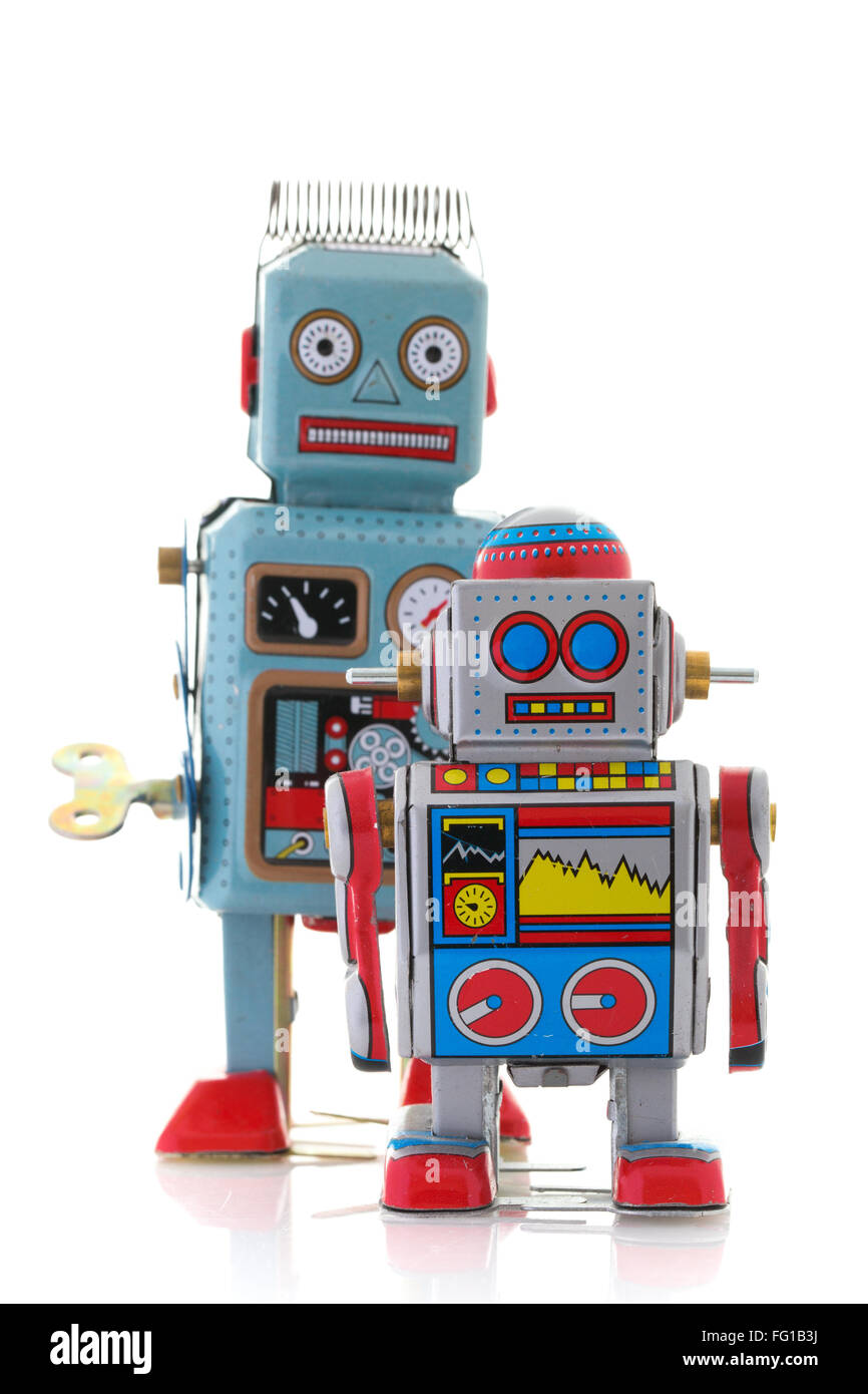 Retro Tin Clockwork Robots sur un fond blanc Banque D'Images