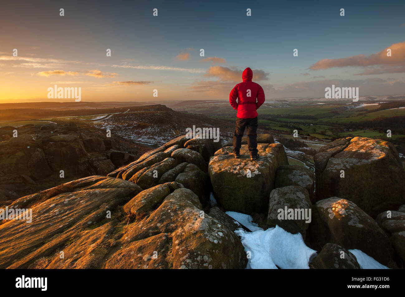 Un marcheur sur Curbar Edge en hiver, Derbyshire, parc national de Peak District. Banque D'Images
