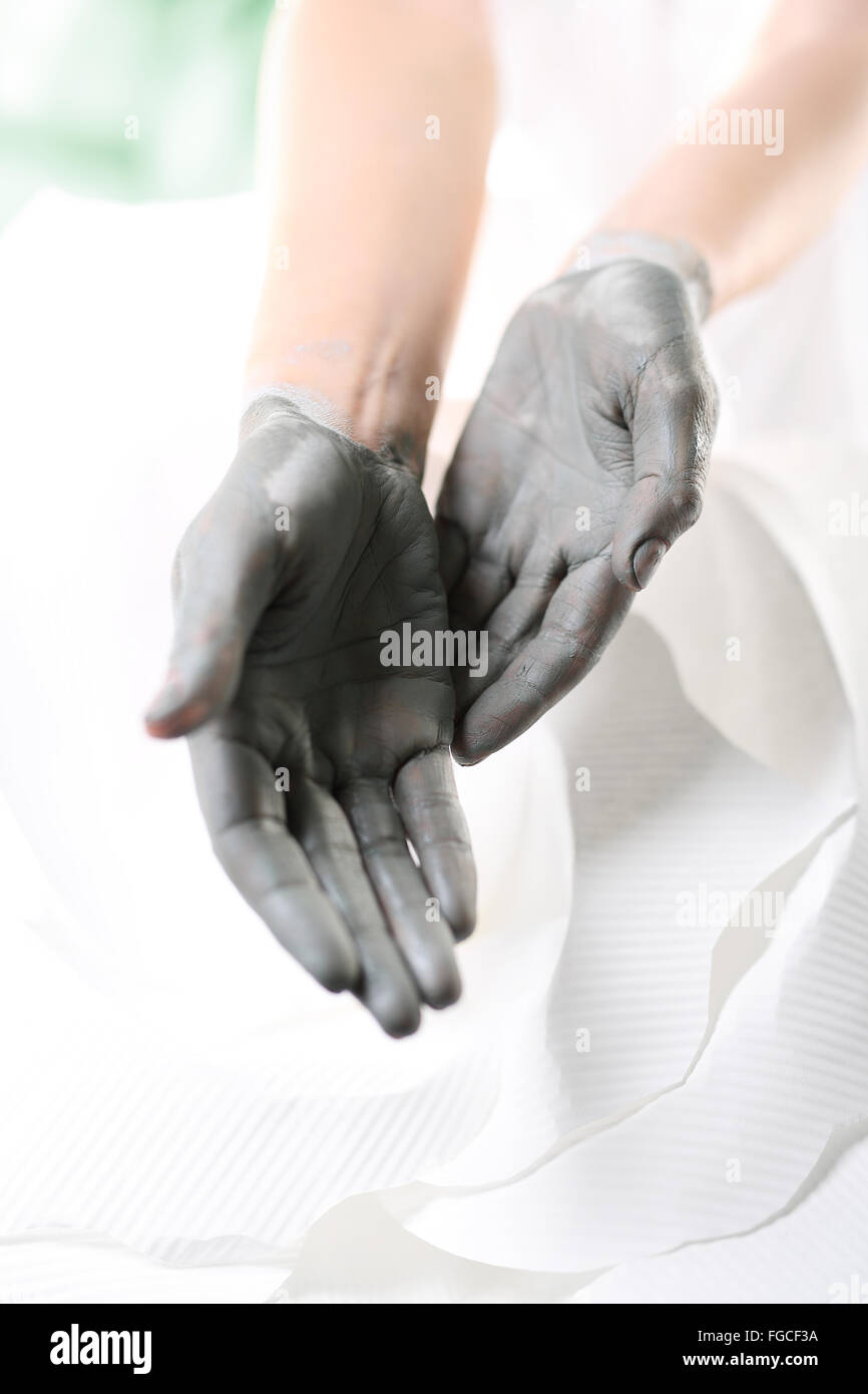 Women's Hands pendant la chirurgie cosmétique mains utilisé avec le masque à l'argile verte. Belles femmes intervention cosmétique Banque D'Images