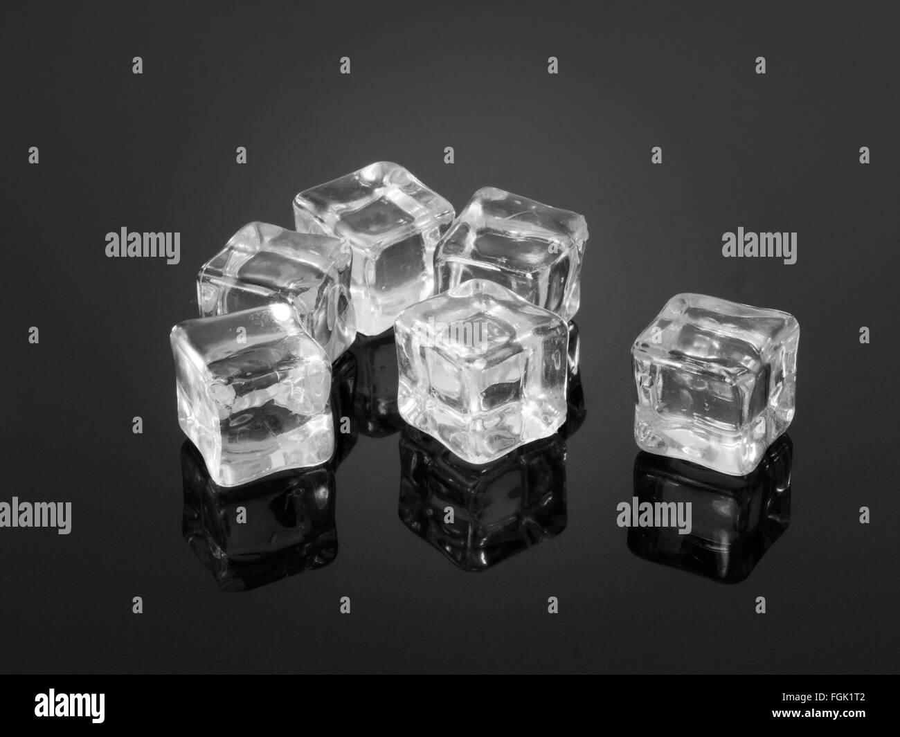 Des cubes de glace en plastique reflétée sur la surface texturée Banque D'Images
