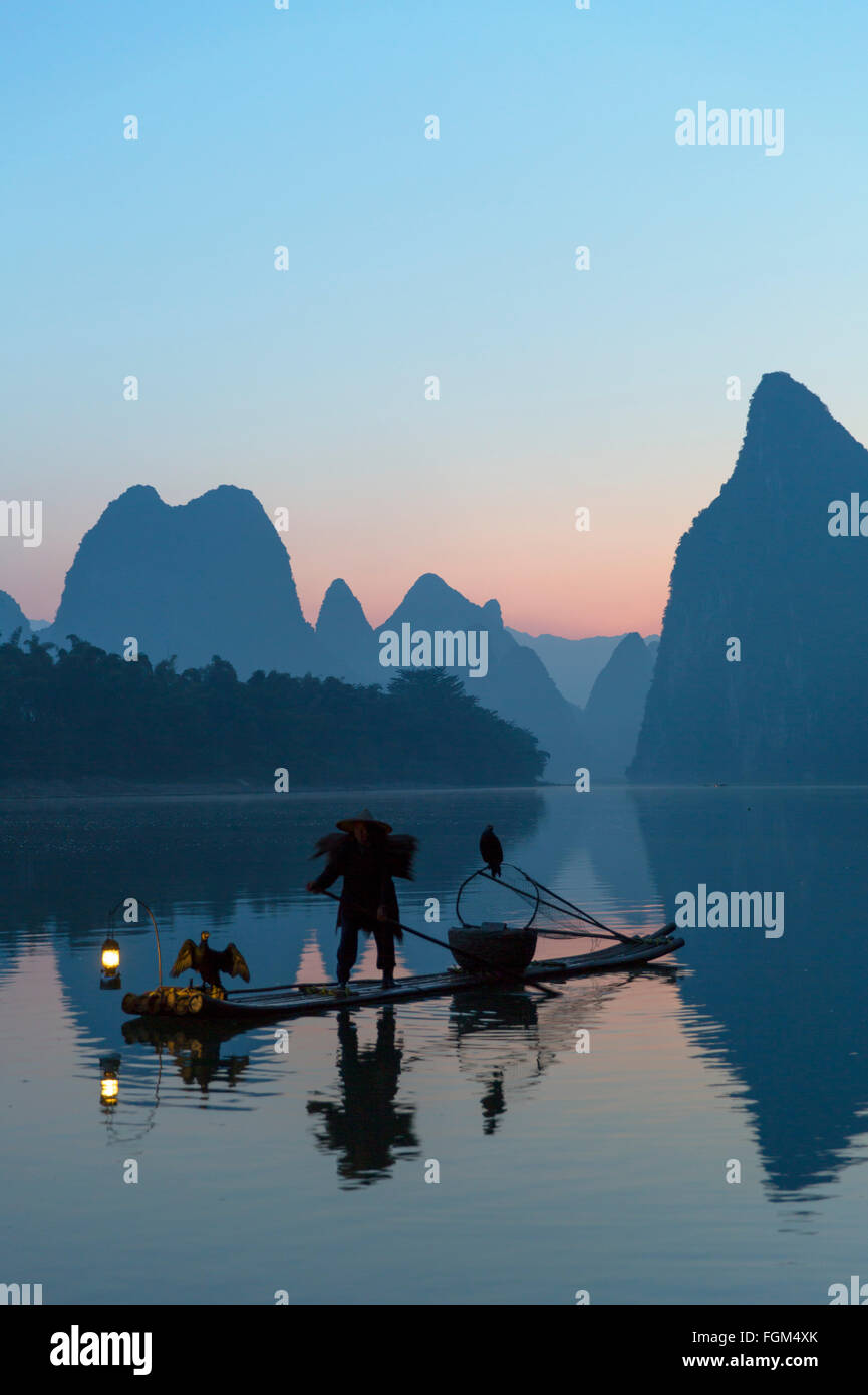 Pêcheur sur la rivière Li Cormorant à l'aube, Xingping, Yangshuo, Guangxi, Chine Banque D'Images