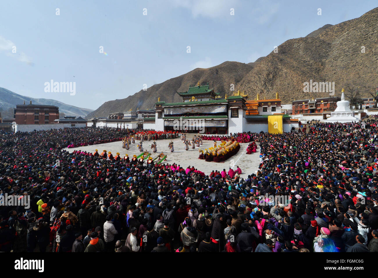 Xiahe, Chine, province de Gansu. Feb 21, 2016. Les gens regardent un spectacle de danse religieuse à un carré de monastère Labrang Xiahe, dans le comté du nord-ouest de la Chine, la province de Gansu, le 21 février 2016. Le monastère de Labrang est l'un des six temples prestigieux de l'école Gelugpa du bouddhisme tibétain. Le spectacle de danse raconter histoires religieuses a attiré des milliers de personnes de la maison et à l'étranger. © Chen Bin/Xinhua/Alamy Live News Banque D'Images