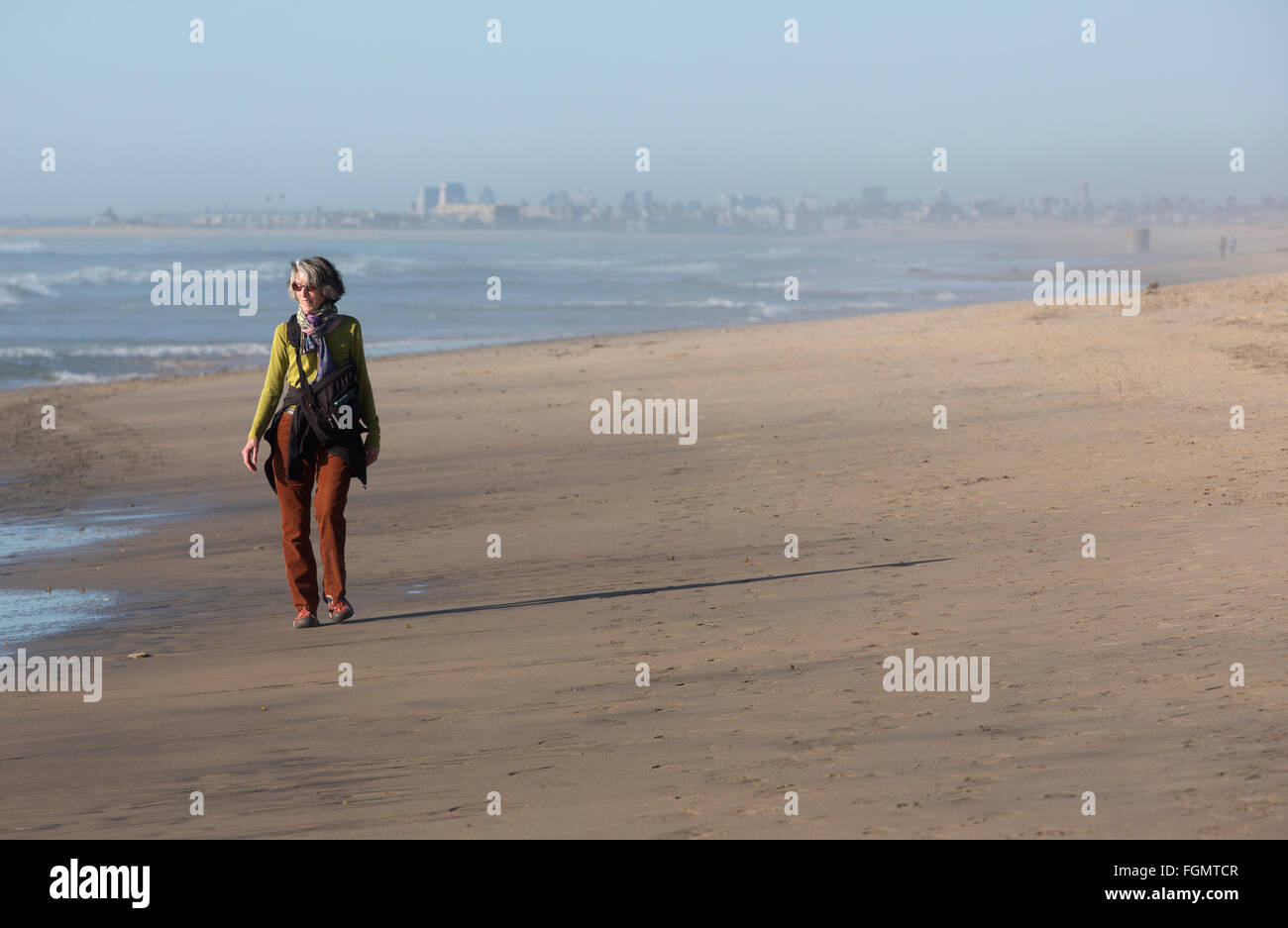 Femme marche sur la plage, NOUS / Mexique frontière près de San Ysidro, en Californie dans le Tijuana River National Estuarine Research Reserve Banque D'Images