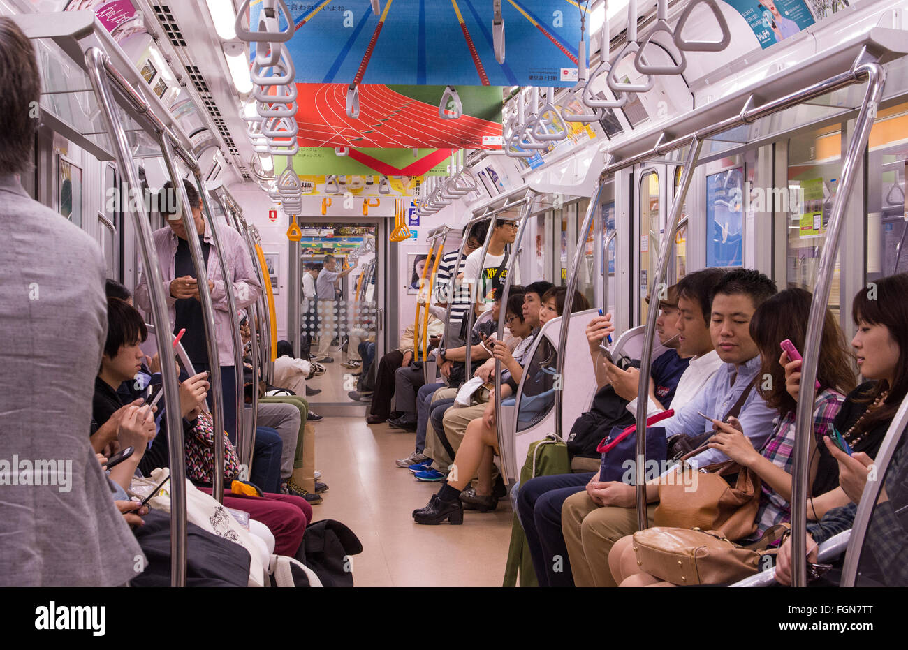 Tokyo Japon foules voiture de métro avec les habitants d'aller travailler dans les transports bondés de cabine de train relaxant assis Banque D'Images