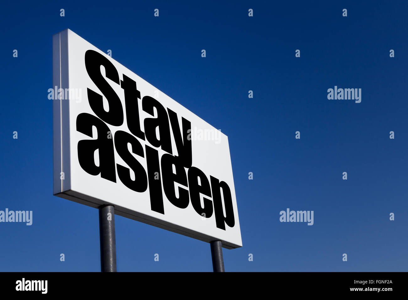 Grand panneau gaufré avec ad, le message 'rester endormi', isolé sur ciel bleu. Banque D'Images