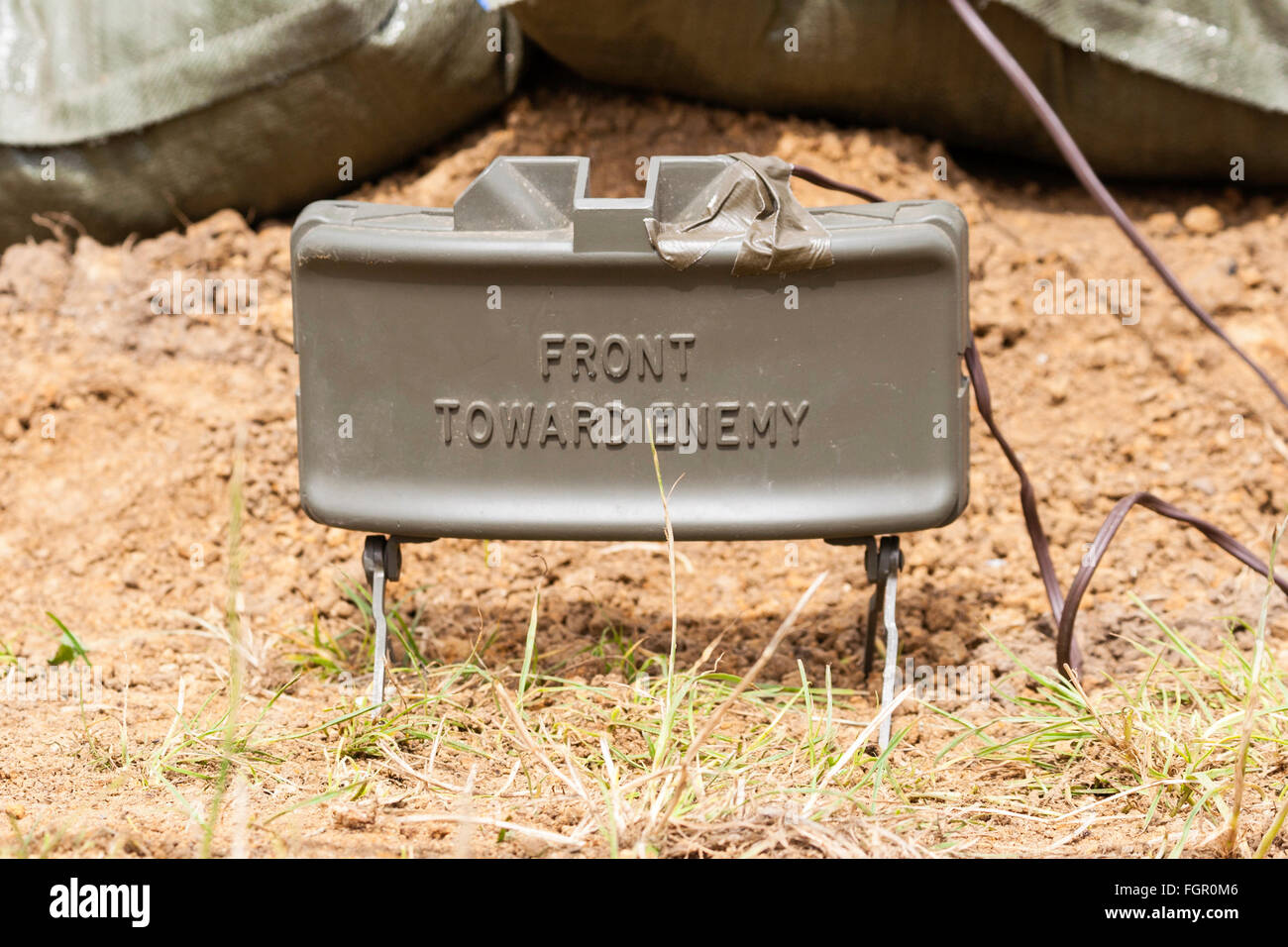 Reconstitution de la guerre du Vietnam. M18 mine Claymore avec M4 détonateur configuré comme piège explosif juste au-dessus de la terre. Sur le boîtier métallique, l'amont vers l'ennemi". Banque D'Images