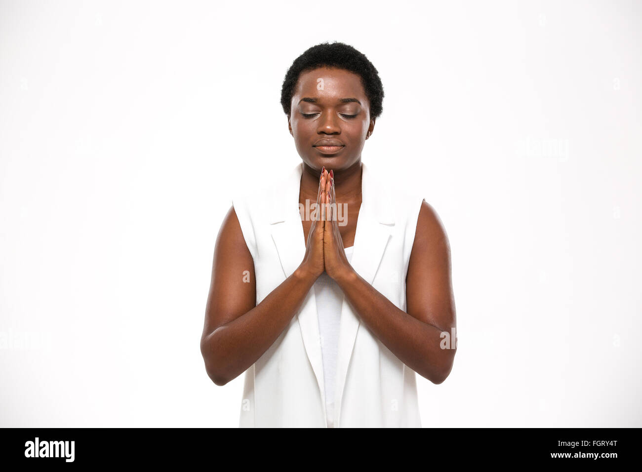 Calm pretty african american woman with closed eyes debout et méditant sur fond blanc Banque D'Images