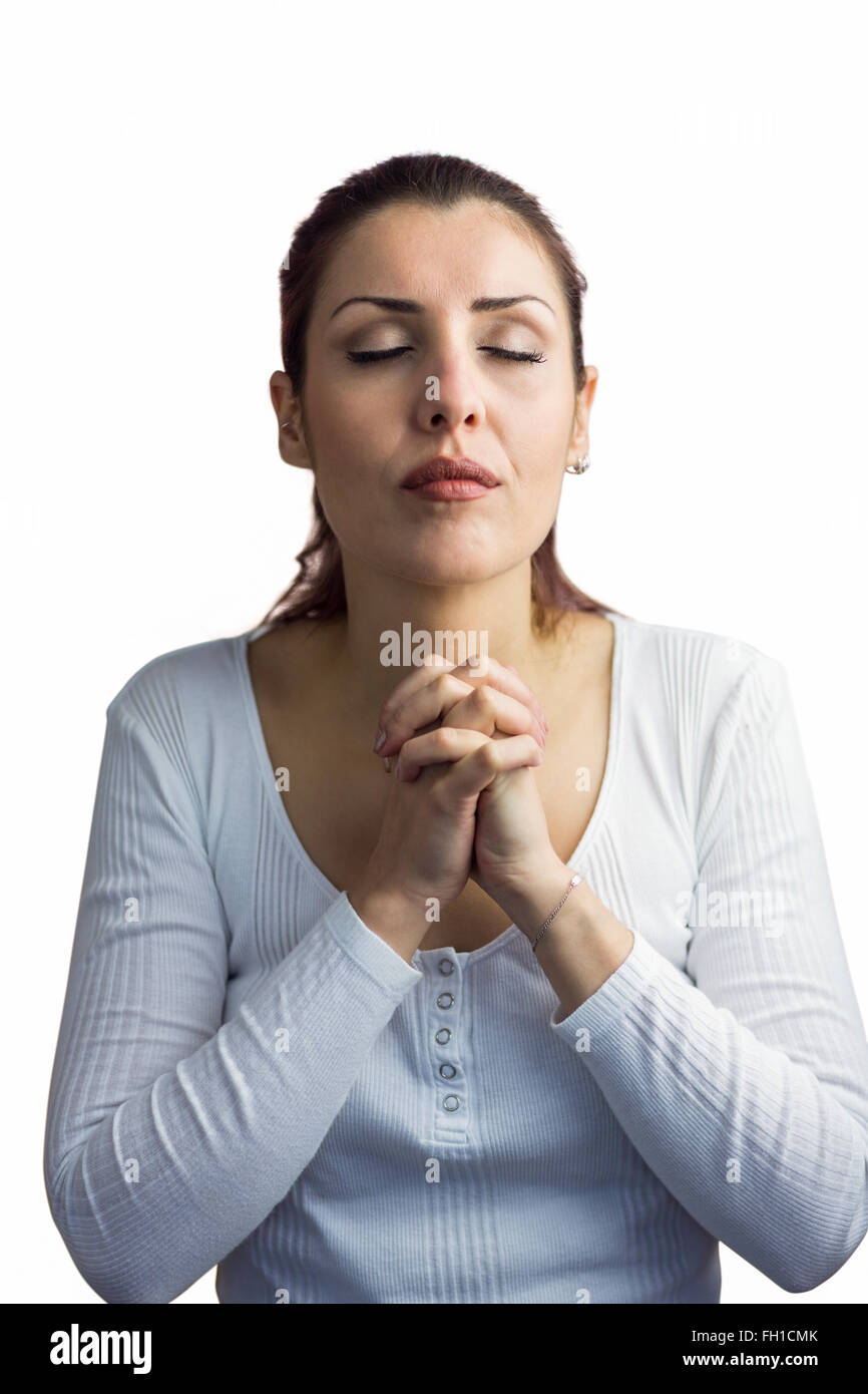 Belle femme priant avec joindre les mains et les yeux fermés Banque D'Images