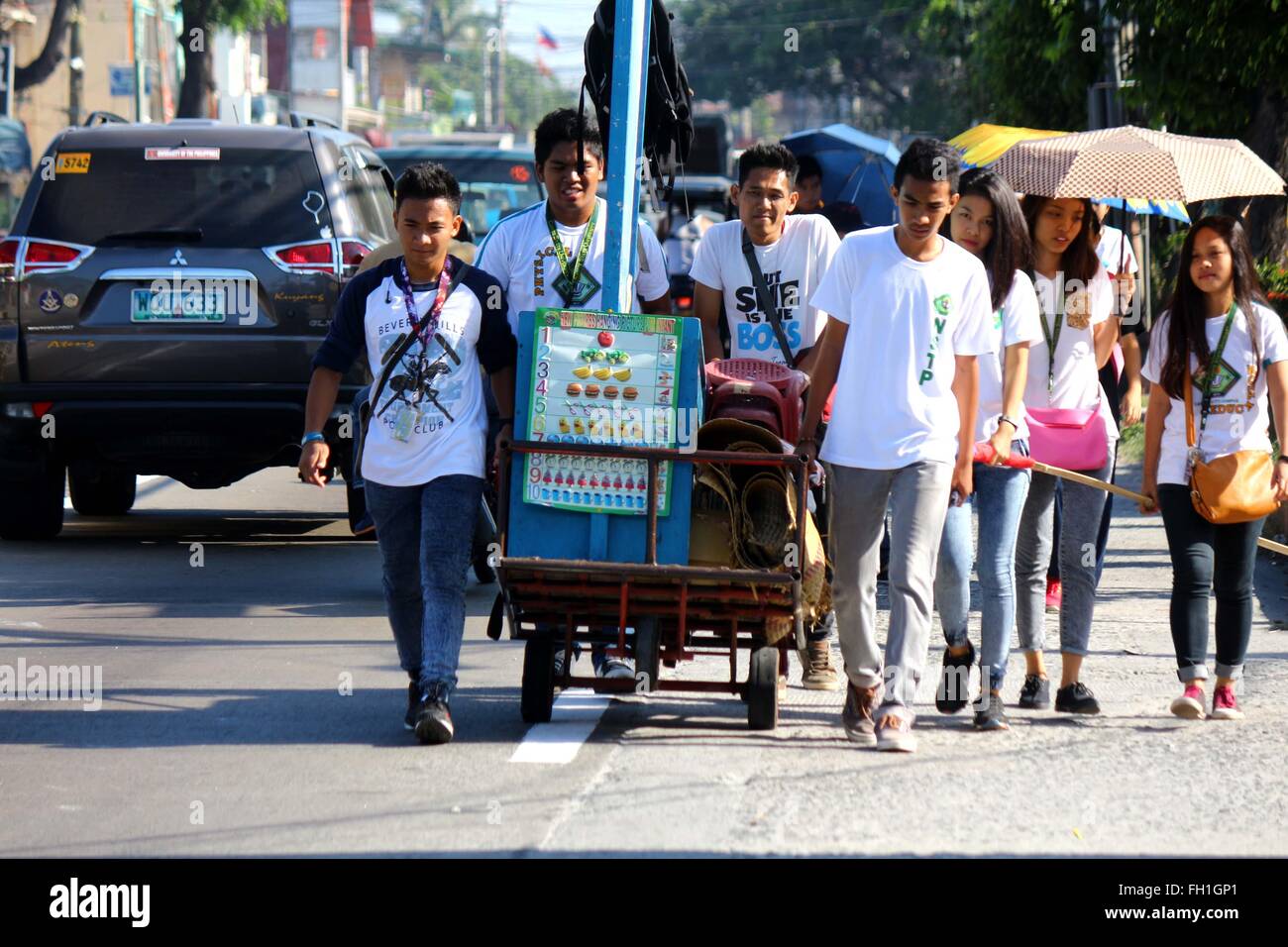 L'adolescent dynamique Company (DTC) bénévoles tout en poussant le Klasrum Kariton sur leur façon de Brgy. 5, rue d'Alonzo, Dalahikan, Cavite City pour leur émission hebdomadaire de l'éducation communautaire. Les fondateurs de DTC s'épanouir comme ils grandissent lentement le nombre de jeunes d'être transformés par l'intermédiaire de leurs programmes. Transformé les jeunes, qui utilisé pour être les utilisateurs de drogue, petits voleurs, les détritivores, enfants des rues, les décrocheurs et les jeunes non scolarisés sont maintenant DTC bénévoles et sont retournés à l'enseignement ordinaire. Bien que certains des enfants ne sont pas scolarisés, au moins, ils sont en mesure d'accéder à l'éducation de base par l'intermédiaire de K4. (Photo Banque D'Images