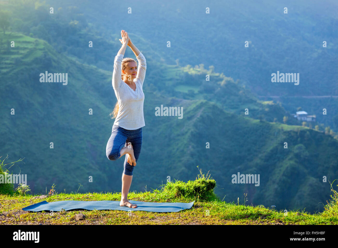 Woman doing yoga asana posture de l'arbre à l'extérieur Banque D'Images