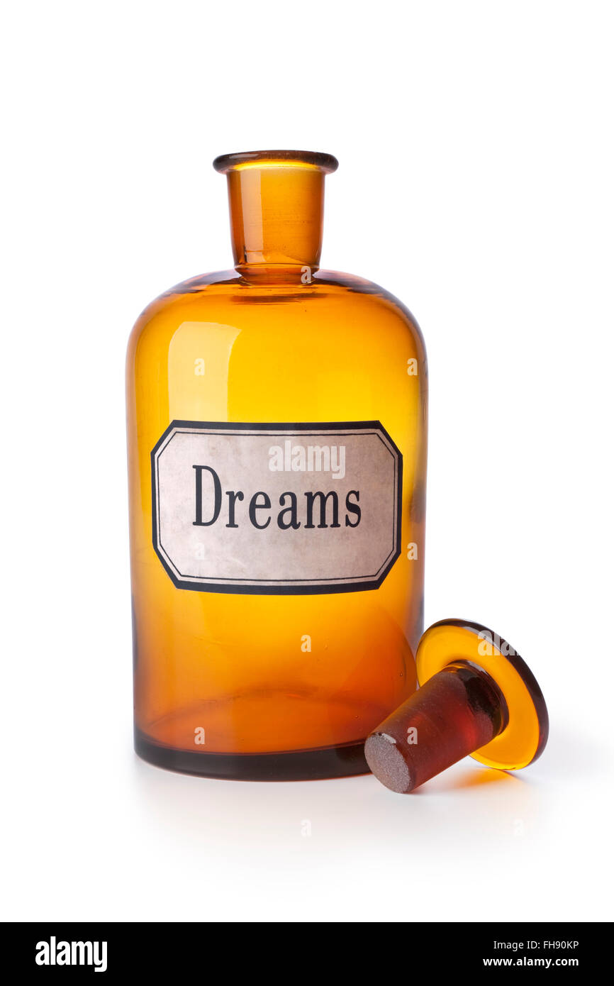 Ancien vide bouteille médecine pharmacie brun avec le mot rêves sur fond blanc Banque D'Images
