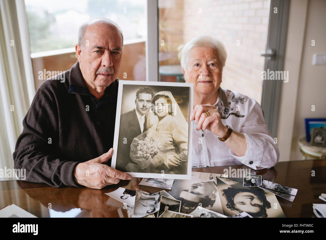 Senior couple montrant leur photo de mariage à la maison Banque D'Images