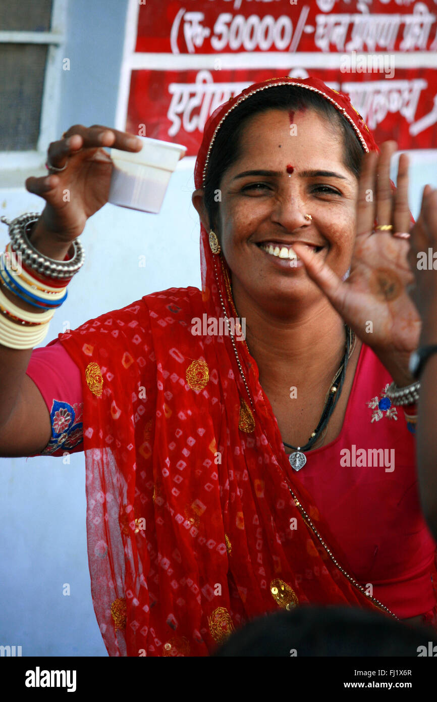 Indian hindu femme à boire le thé au cours de Pushkar foire de chameau au Rajasthan, Inde Banque D'Images