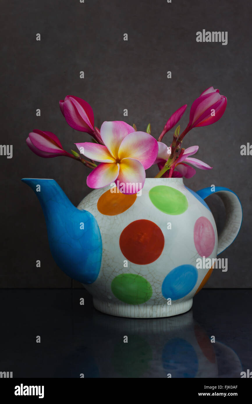 La vie toujours belle belle fleur rose plumeria bunch décorées de motifs en pointillés colorés tea pot Banque D'Images