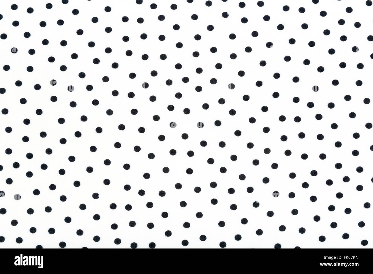 Un tissu blanc avec des points noirs en arrière-plan Banque D'Images