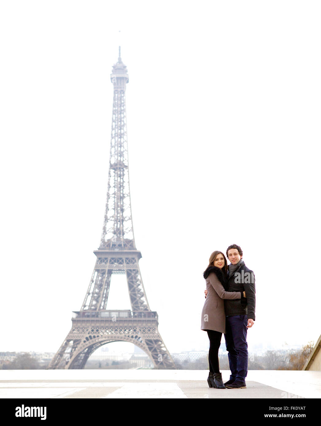 Les jeunes et dans l'amour brunette couple in front of Eiffel tower, Paris, au Trocadéro sur la ville pendant la journée - à la Banque D'Images