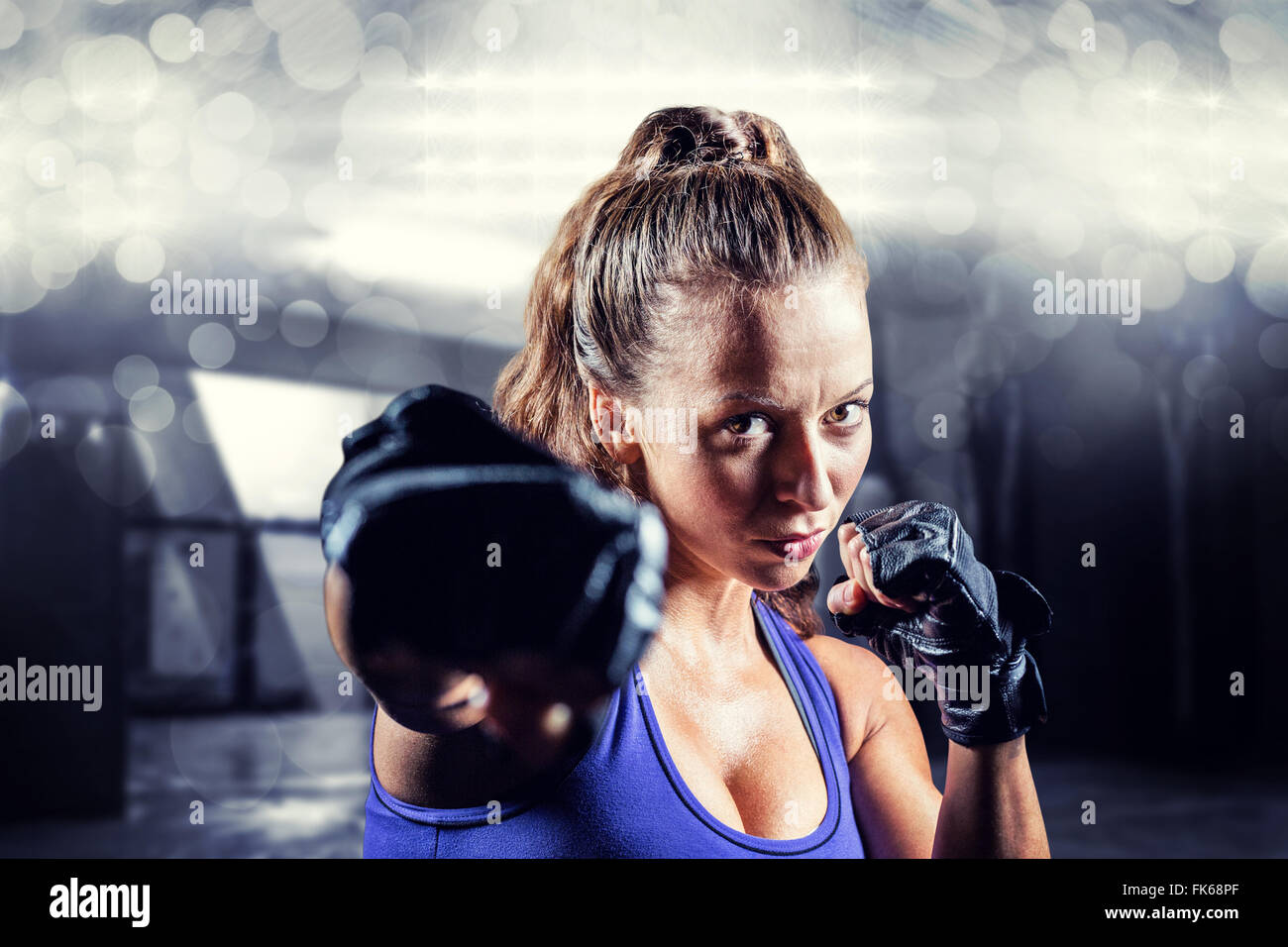 Image composite de portrait of female fighter punching Banque D'Images