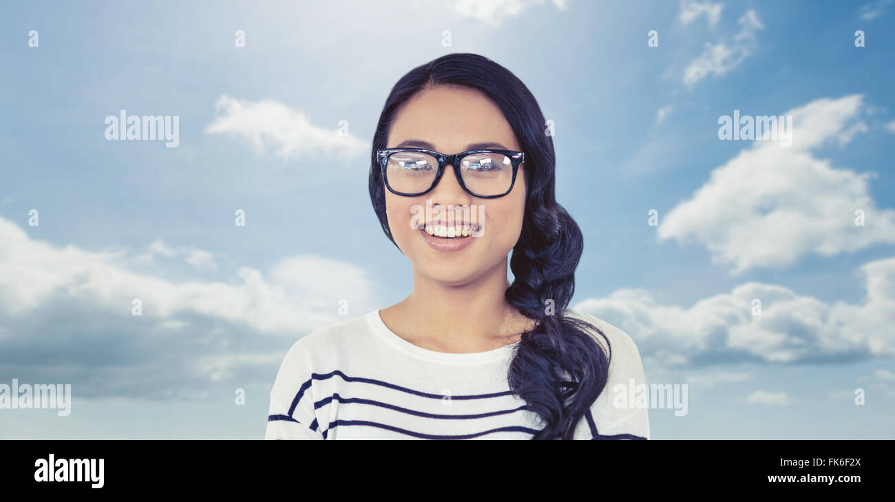 Composite image of woman with arms crossed looking at the camera Banque D'Images