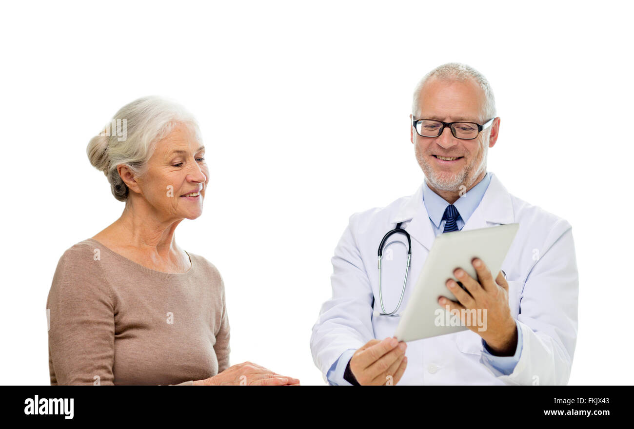 Smiling senior woman and doctor with tablet pc Banque D'Images