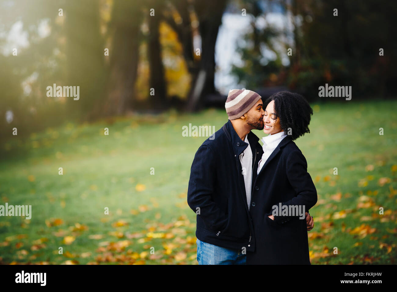 Couple kissing in park Banque D'Images